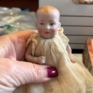 Two small German bisque dolls, molded hair, larger has dimples